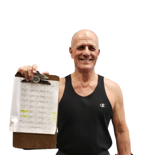 Wally, personal trainer at Body By Wally, holding up a customized exercise plan for clients in Augusta.