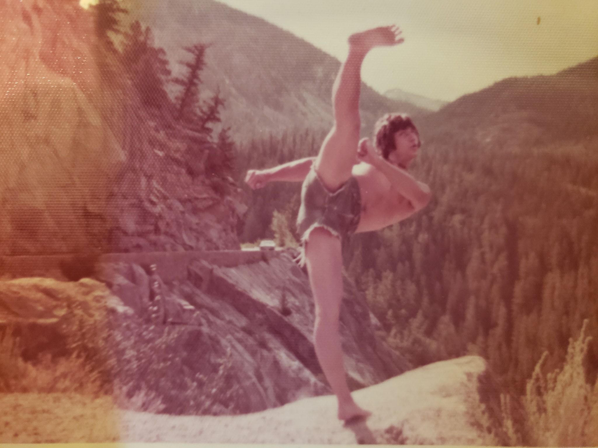 Wally in his youth performing a high kick, showcasing strength and agility at Body By Wally.